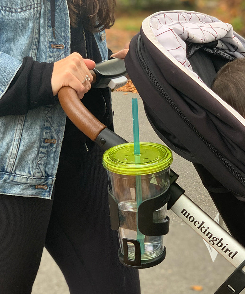 Mockingbird stroller with green travel cup in cupholder