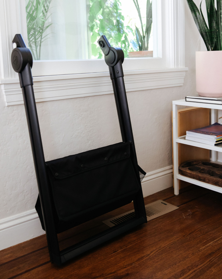 Mockingbird bassinet stand folded up against the wall