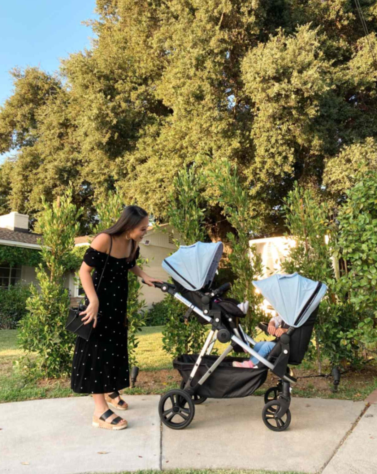 a mom staring into her two little ones while they are in the mockingbird single to double stroller