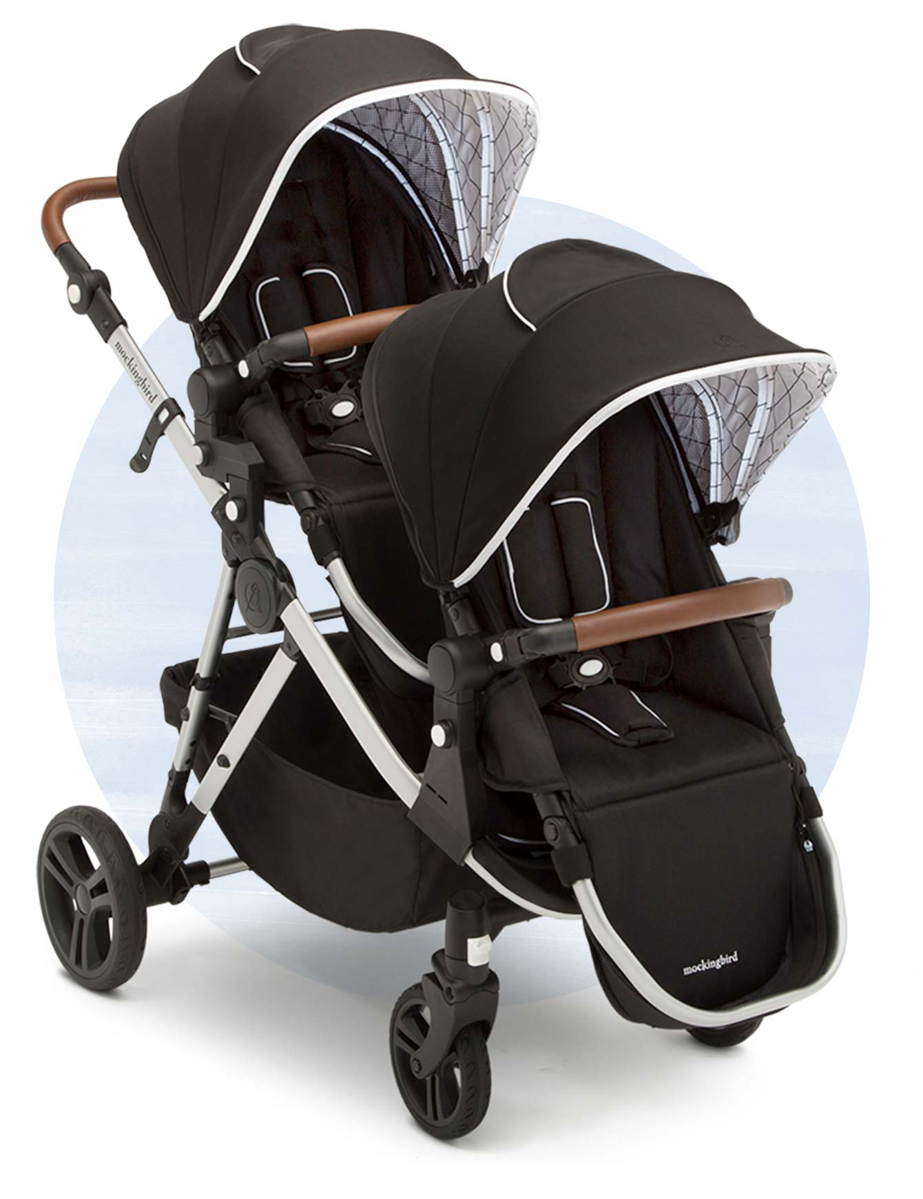 A double baby stroller with black canopies, spacious seating, and a modern design on a white background.