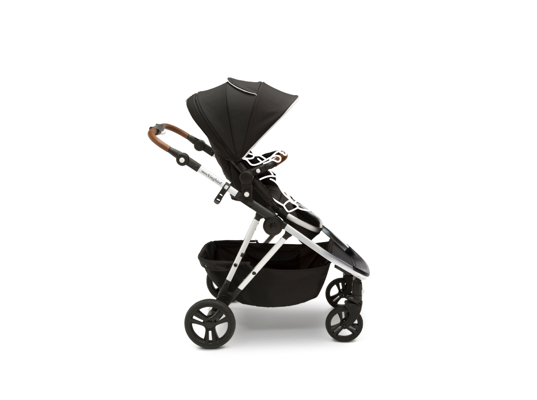 Modern black baby stroller with an adjustable canopy and a spacious undercarriage basket, isolated on a white background.