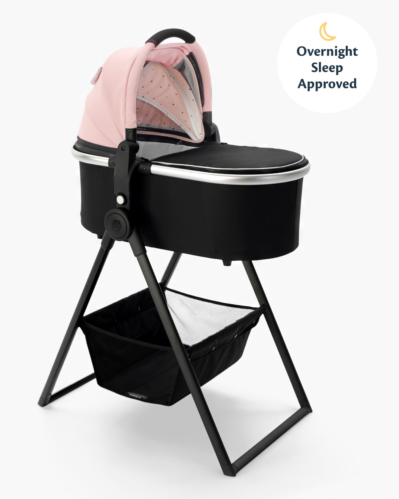 A black mockingbird-prod bassinet on a metal mockingbird-prod bassinet stand, featuring an attached pink baby backpack with an "overnight sleep approved" label. #color_bloom