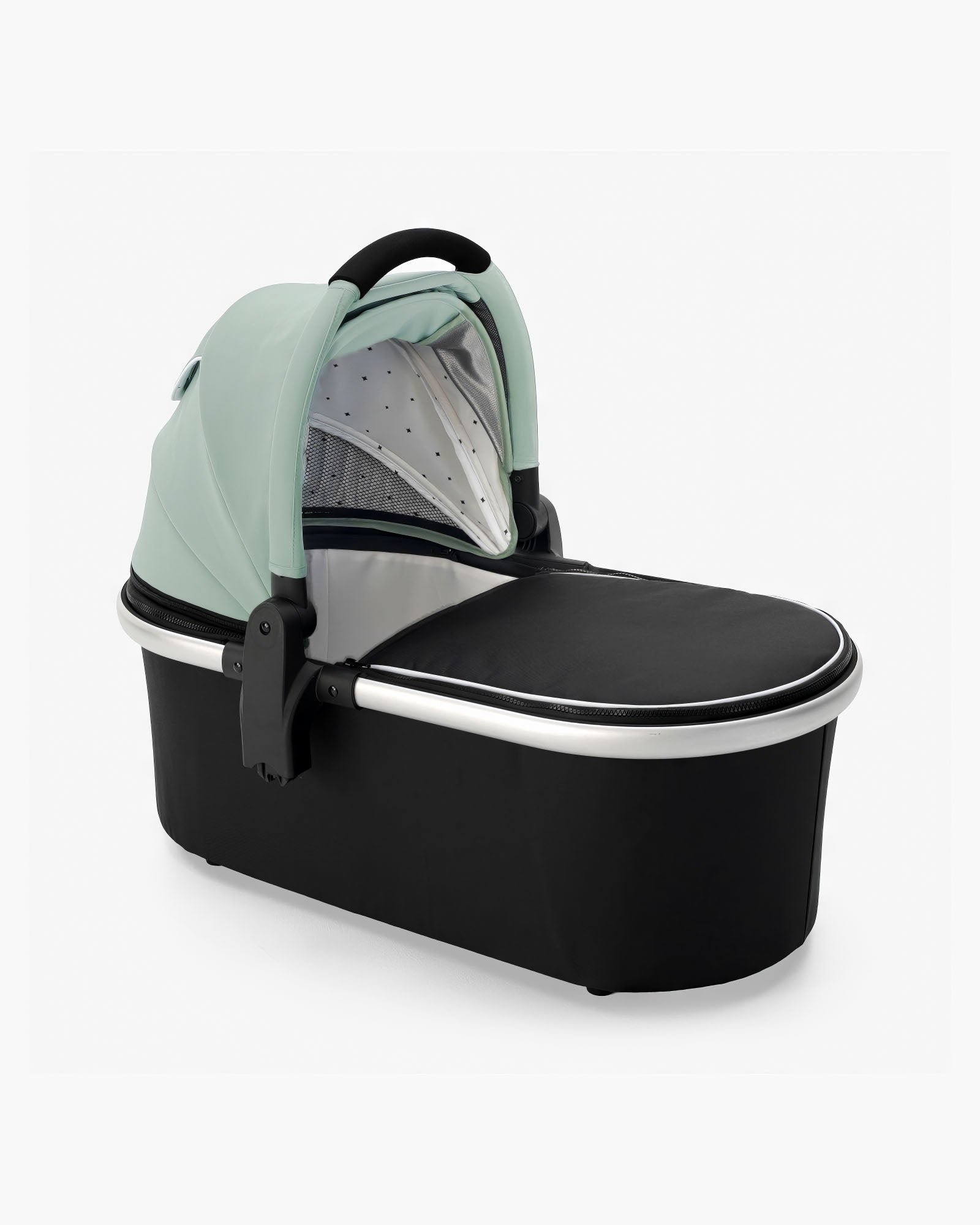 A modern mockingbird-prod baby bassinet in mint green and black, featuring a handle and a partially visible grey dotted interior, complete with a sturdy bassinet stand. #color_sage