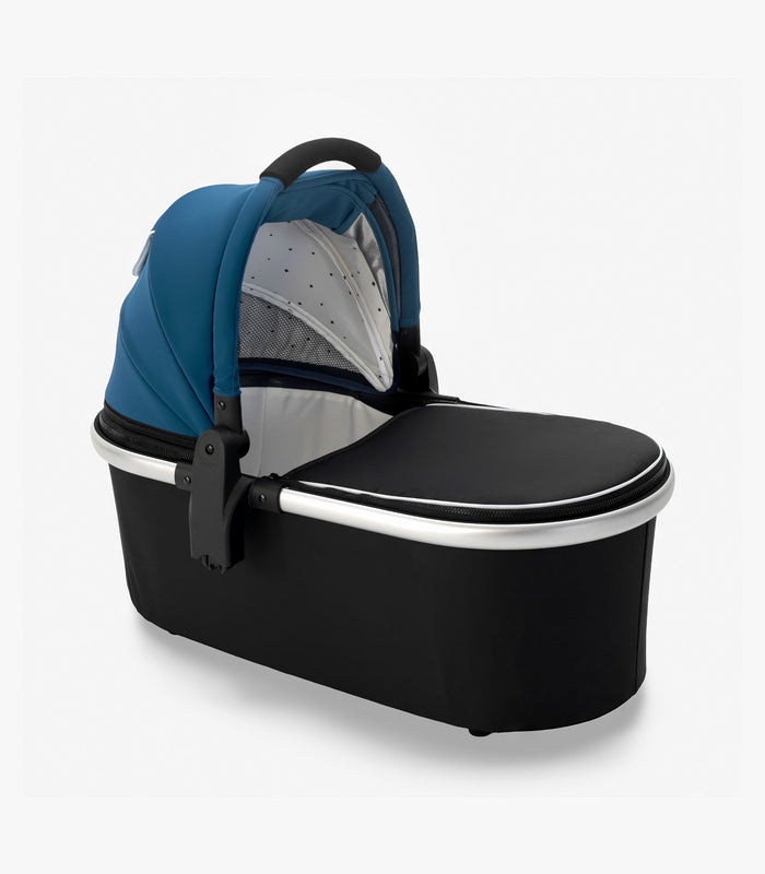 A sleek modern mockingbird-prod baby bassinet stand in black and blue with a transparent mesh panel on a white background. #color_sea