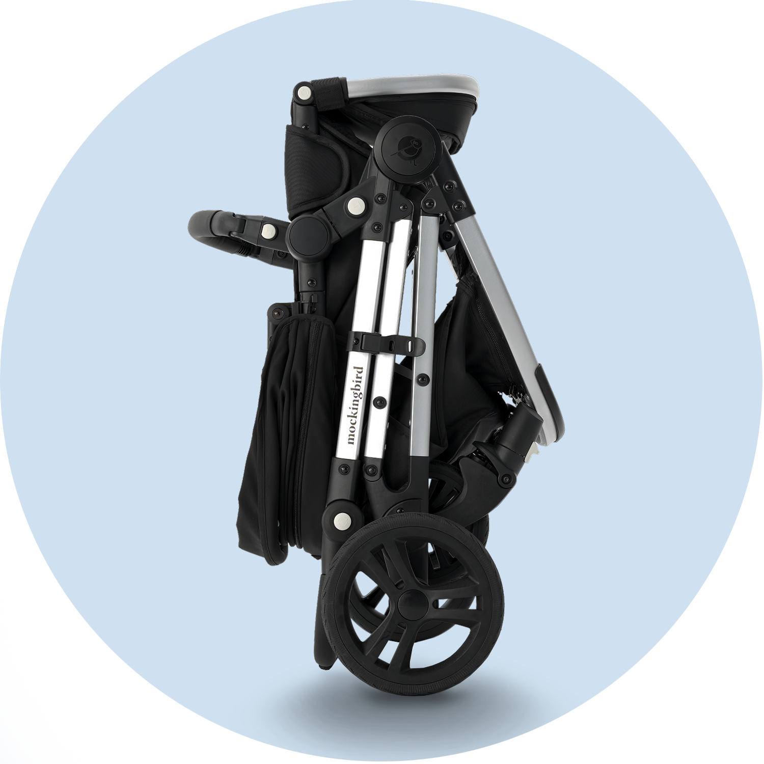 Black, foldable baby stroller against a light blue background, featuring large wheels and a storage compartment.