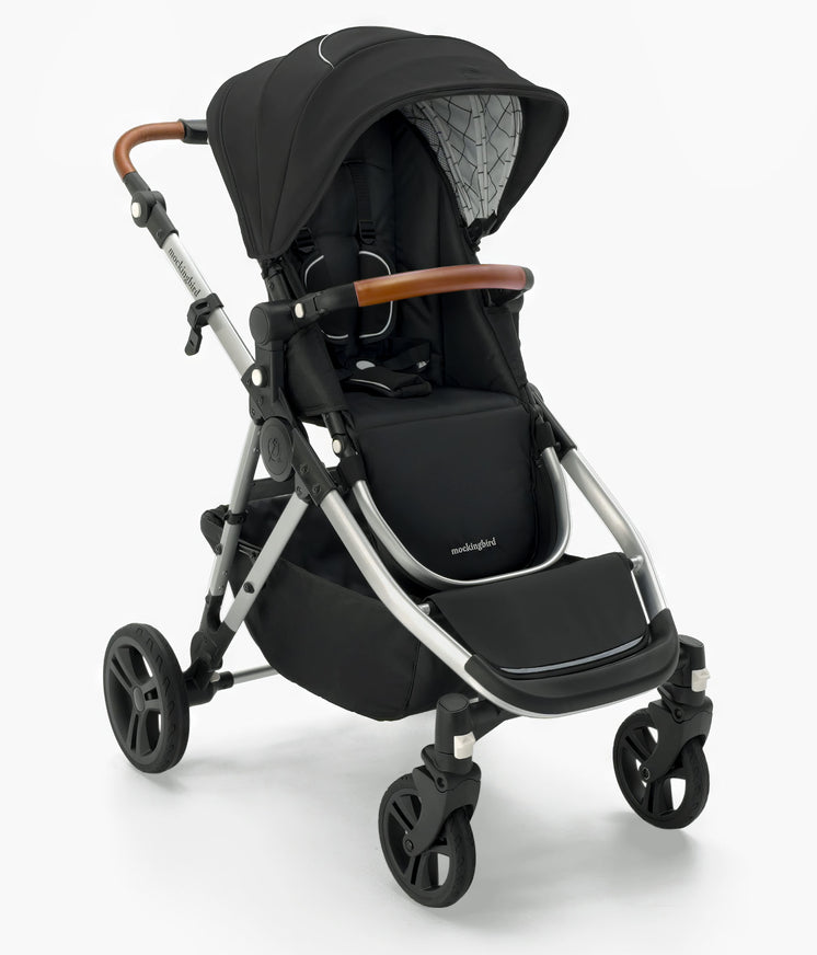 Modern black Mockingbird Single-to-Double Stroller 2.0 with brown handles, adjustable hood, sturdy wheels, and a mockingbird-prod label, isolated on a white background. #color_black