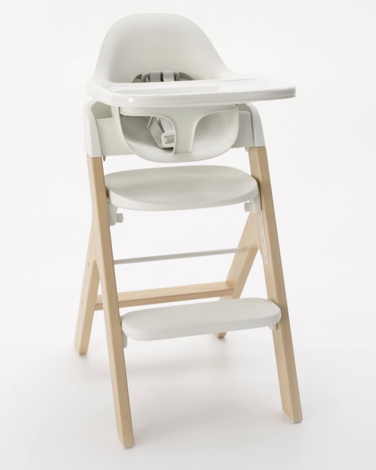 3/4 front view of mockingbird high chair with tray in studio on light grey background