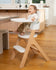 small child sitting in mockingbird high chair in kitchen area