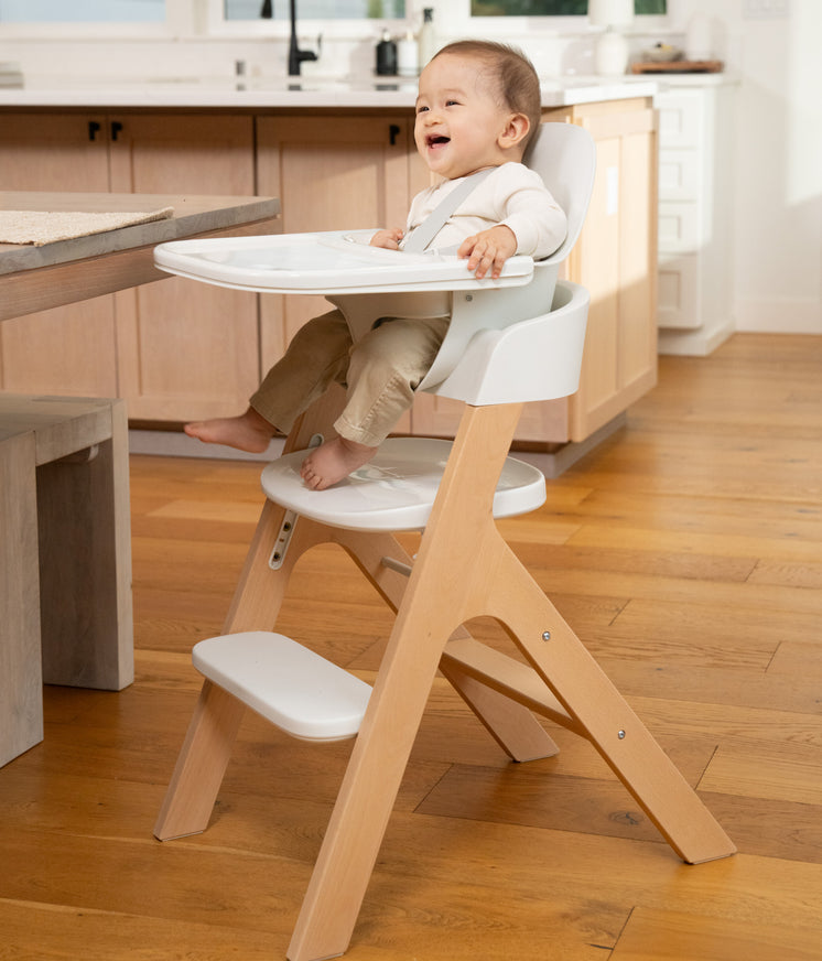 small child sitting in mockingbird high chair in kitchen area