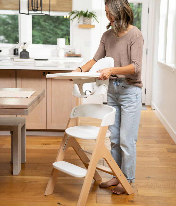 mom transitioning the mockingbird high chair from high chair mode to child mode