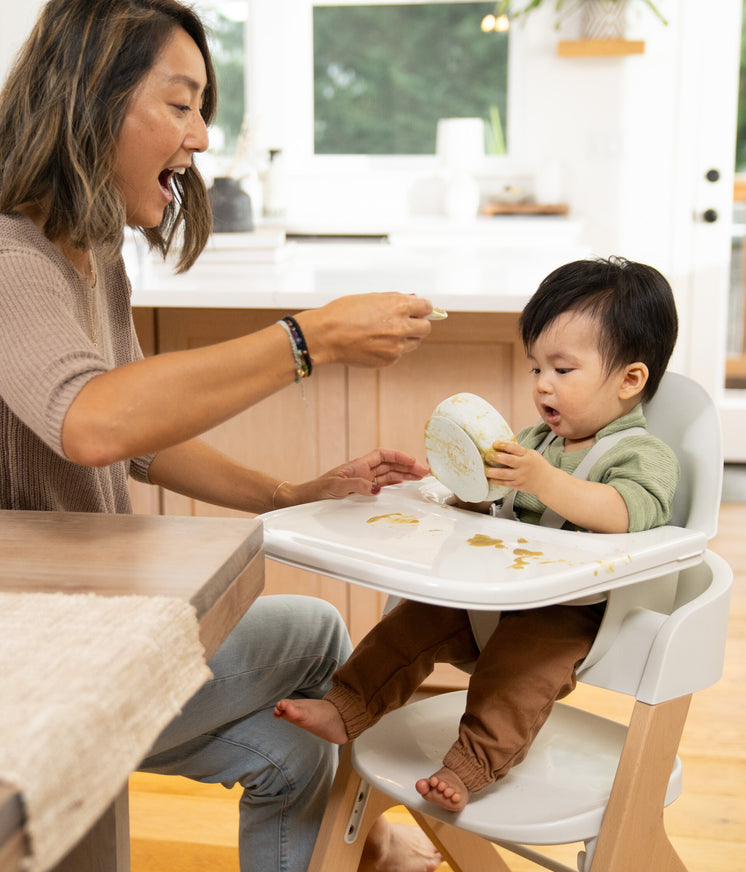 small child making a mess while eating 