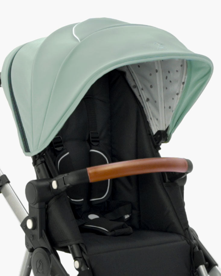 Modern mockingbird-prod stroller with an Extra Stroller Canopy 2.0 in light green, adjustable handle, and black seat with safety harness. #color_sage