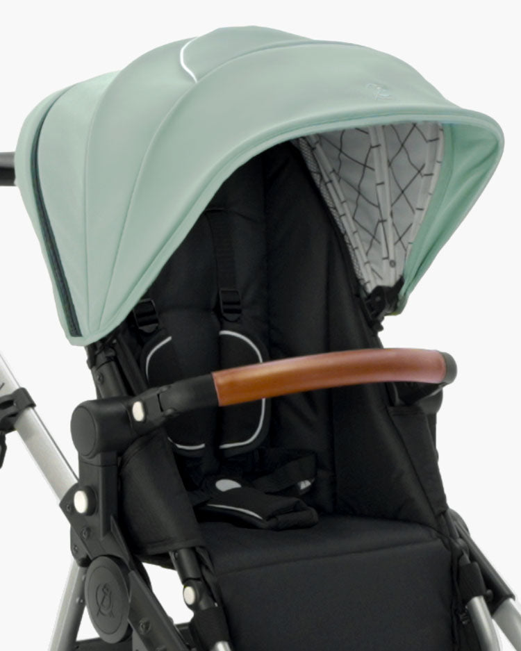 Close-up of a modern mockingbird-prod Mockingbird stroller with a mint green Extra Stroller Canopy 2.0, black seat, and a brown leather handle. #color_sage