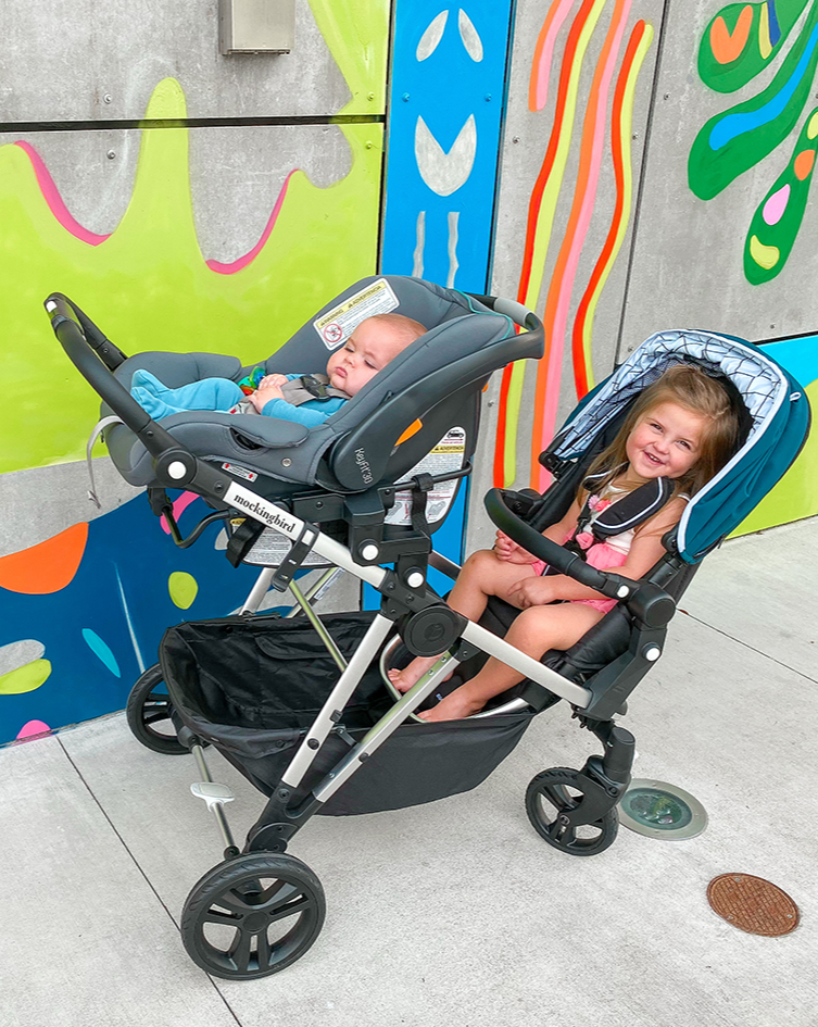 Infant and Toddler in the Mockingbird Single-to-Double Stroller with Car Seat Adapter attached