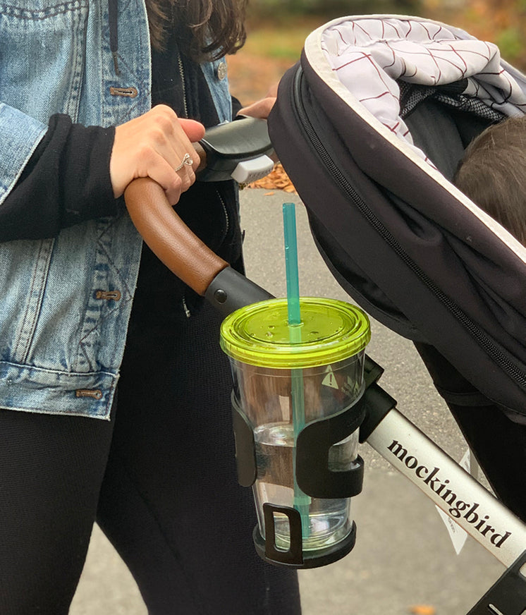 Mockingbird stroller with green travel cup in cupholder