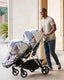Father pushing a Mockingbird Single-to-Double Stroller with two Rain Covers