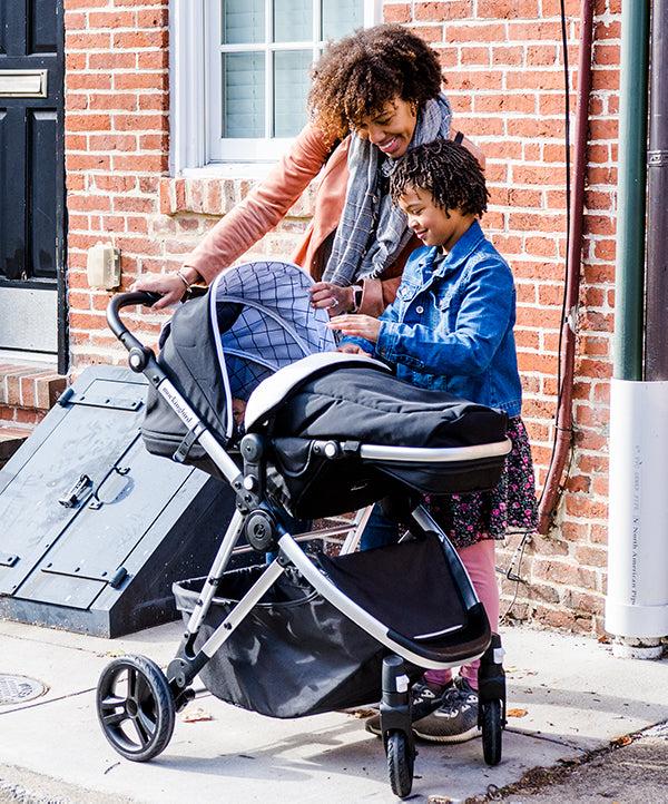 Mockingbird Footmuff | Mother and child standing next to Stroller