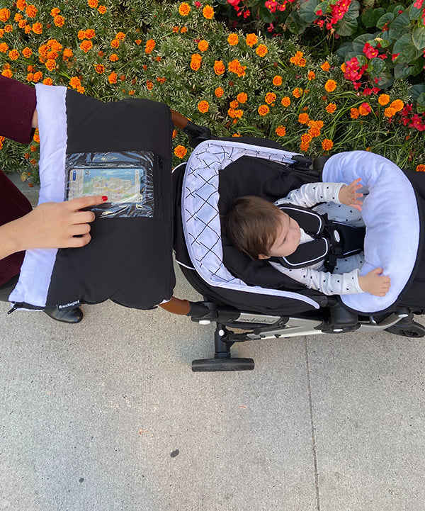 Mockingbird Hand Muff | Parent using the Hand Muff and pushing their child in the Mockingbird Stroller